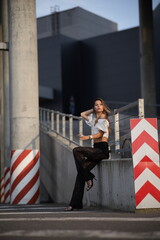 Woman posing on the road wearing fashionable clothes