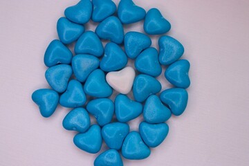 A white heart among blue ones: a visual metaphor for uniqueness, inner peace, and the strength to be yourself in a world of expectations