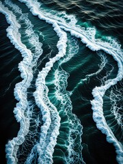 Aerial ocean view, foamy waves rolling over deep blue water