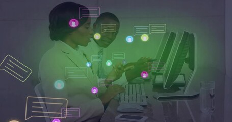 Woman tapping smartphone and man typing at office desk, spawning chat bubbles managing conversation - Powered by Adobe