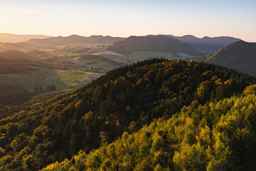 A beautiful mountain landscape seen from the new observation tower on Dzikowiec Wielki. Sunrise in the town of Boguszow Gorce. The Kamienne and Walbrzych Mountains.