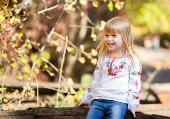 Joyful Girl Enjoying an Autumn Day Outdoors, Surrounded by Vibrant Fall Colors and the Spirit of Halloween in October