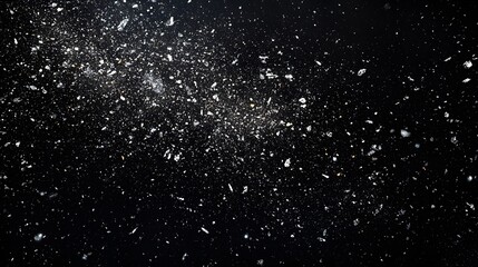 Obraz premium Sparkling particles against a dark, starry background.
