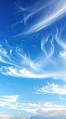 Stunning, wispy clouds dance across a vibrant blue sky