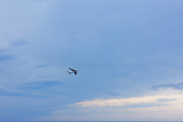 Airplane flying in beautiful blue sky, low angle view