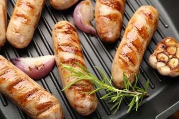 Pan with grilled sausages and spices, top view
