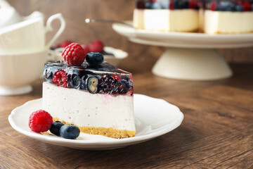 Piece of delicious cheesecake with berries on wooden table, closeup