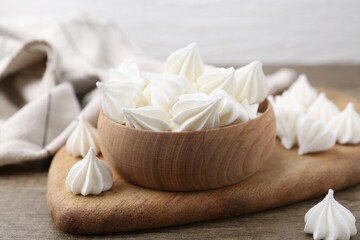 Delicious meringue cookies on wooden table, closeup