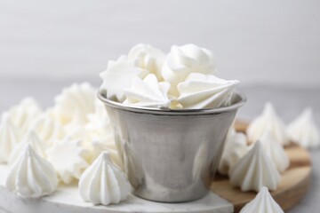 Delicious meringue cookies on grey table, closeup