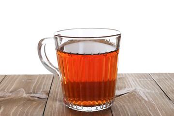 Cup of aromatic black tea on wooden table against white background