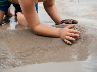 Child Playing with Sand on Beach – Summer Vacation Fun