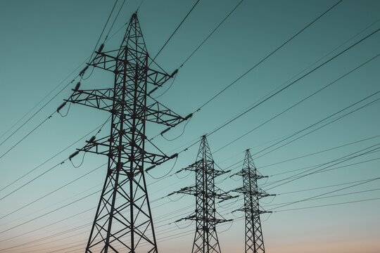 silhouette of high-voltage metal poles of power lines