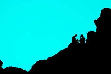 two people are sitting opposite each other on a cliff, overcoming difficulties and then relaxing together