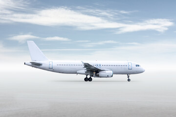 White passenger airliner isolated on bright background with sky