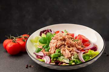 Tuna salad canned fish, tomato, green leaf salad vegetable dish natural tasty snack fresh gourmet food background on the table rustic top view copy space keto paleo diet vegetarian food pescetarian