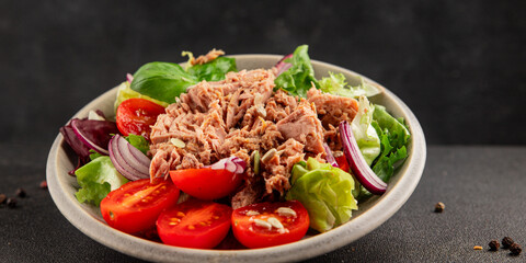 Tuna salad canned fish, tomato, green leaf salad vegetable dish natural tasty snack fresh gourmet food background on the table rustic top view copy space keto paleo diet vegetarian food pescetarian