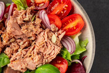 Tuna salad canned fish, tomato, green leaf salad vegetable dish natural tasty snack fresh gourmet food background on the table rustic top view copy space keto paleo diet vegetarian food pescetarian