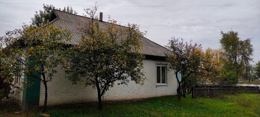 Old Rural House With Fruit Trees in a Quiet Setting During Overcast Weather