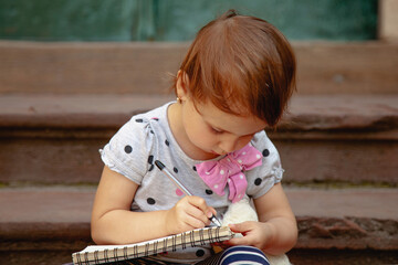Creative child planning her imaginary project.