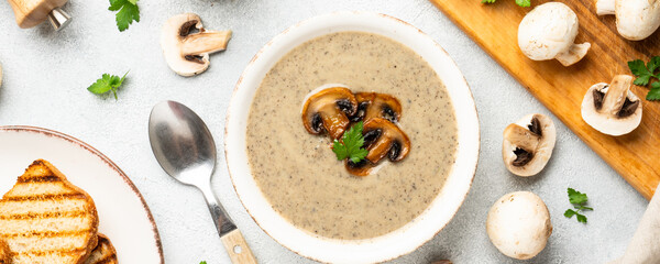 Mushroom soup puree on white kitchen table.