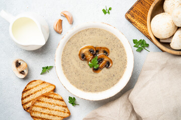 Mushroom soup puree on white kitchen table.