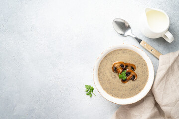 Mushroom soup on white background with ingredients for cooking.