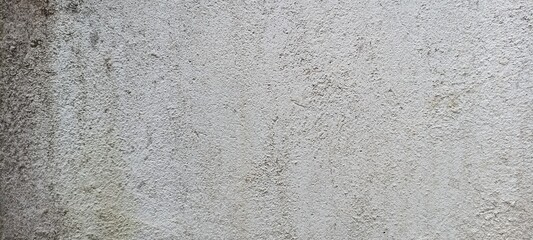Aged Rough Concrete Wall Texture with Natural Stains. Close-up of aged rough concrete wall with natural stains and uneven surface, ideal for grunge or rustic background use