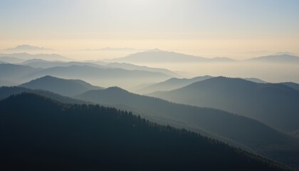 Obraz premium aerial cinematic shot of mountain ridges under early fog, layered gradient tones, film like softness.