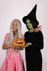 girls as witches with pumpkins