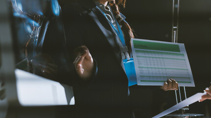 Close up high angle Asian businesswoman working with her coworker in meeting room