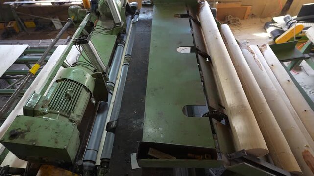 A veneer sheet production machine processes logs into thin sheets. The industrial equipment prepares timber for plywood manufacturing.
