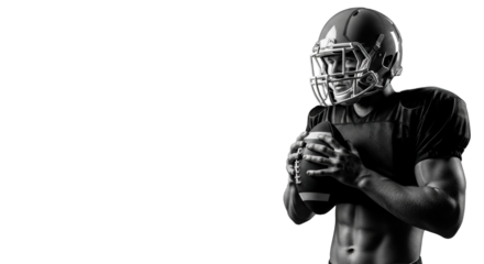 An athletic male American football player with defined musculature, in a dark jersey and helmet, gripping a football on a pure black background with copy space, concept of athletic strength and