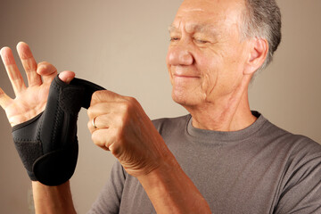 Man wearing a Black Wrist and Thumb Support Brace for Arthritis and Thumb pain