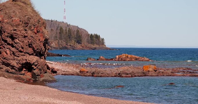 Rocky shore, beach and seagulls at the rocky North Shore of Lake Superior, or Gichi Gami, on a sunny day in northern Minnesota.