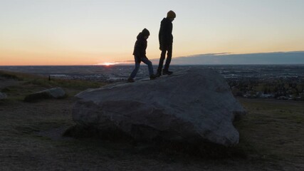 Children playing outdoors at sunrise on a cool Autumnal morning