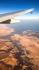 Aerial view of a desert landscape with wing