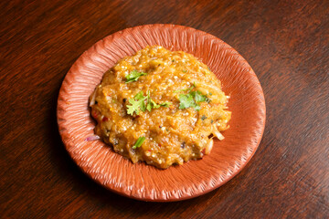 Spicy Bengali Begun Bhorta Smoky Mashed Eggplant on Rustic Plate side view of bangladeshi food
