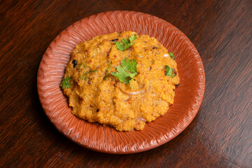 Dal Bhorta topped with coriander on Rustic Plate side view of bangladeshi food