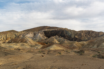 Striped Multicolored Hills with Rocky Foreground Under Cloudy Sky, 20 Mule Team Canyon, Death Valley National Park