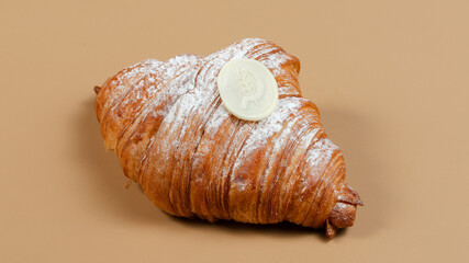 Croissant with sugar powder isolated from side