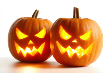 Two glowing jack-o-lanterns with carved faces perfect for Halloween decorations and spooky seasonal themes isolated on white