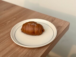 Chocolate bread (roti cokelat) served on a white plate — a simple and delicious Indonesian snack or breakfast pastry. BSD, Indonesia - October 5, 2025