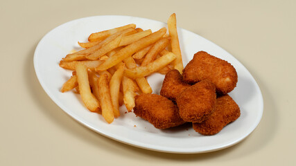 Chicken nuggets and fries on plate