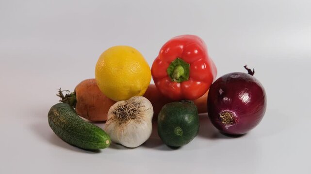 Hand of man replaces fresh vegetables with a bottle of multivitamins on a white surface, highlighting the balance between healthy eating and dietary supplements for wellness