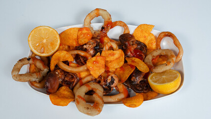 Seafood assortment on big plate. Crab, crawfish, omar, squid rings, prawns