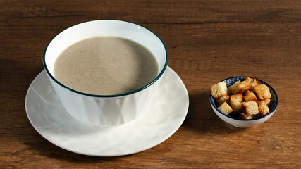 Mushroom soup bowl on wooden table