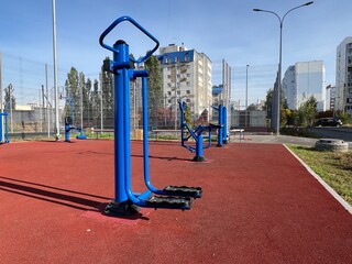 An outdoor fitness and training area with exercise equipment in a modern residential courtyard