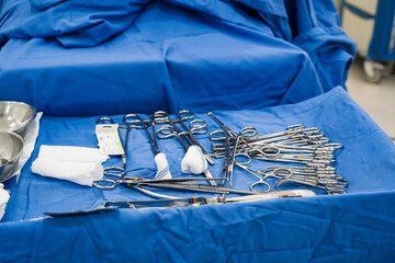 Sterile surgical instruments arranged on blue drape in operation room