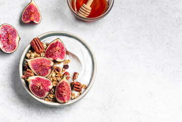 Granola breakfast bowl with figs, honey and pecan nuts
