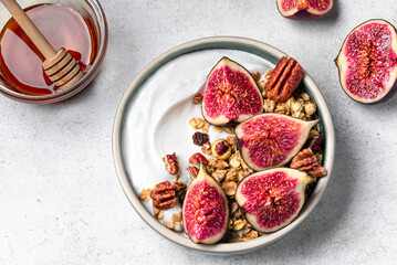 Granola breakfast bowl with figs, honey and pecan nuts